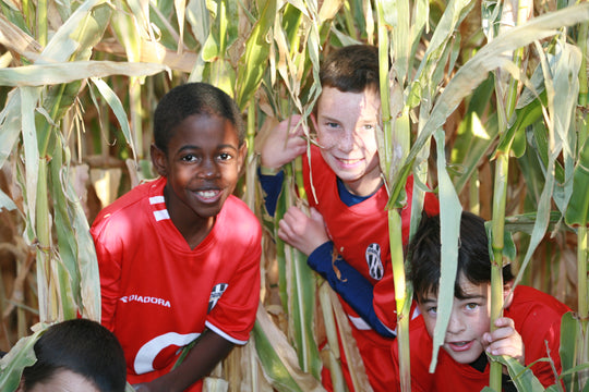 Maze_Boys_Soccer team_smiling peeking.JPG